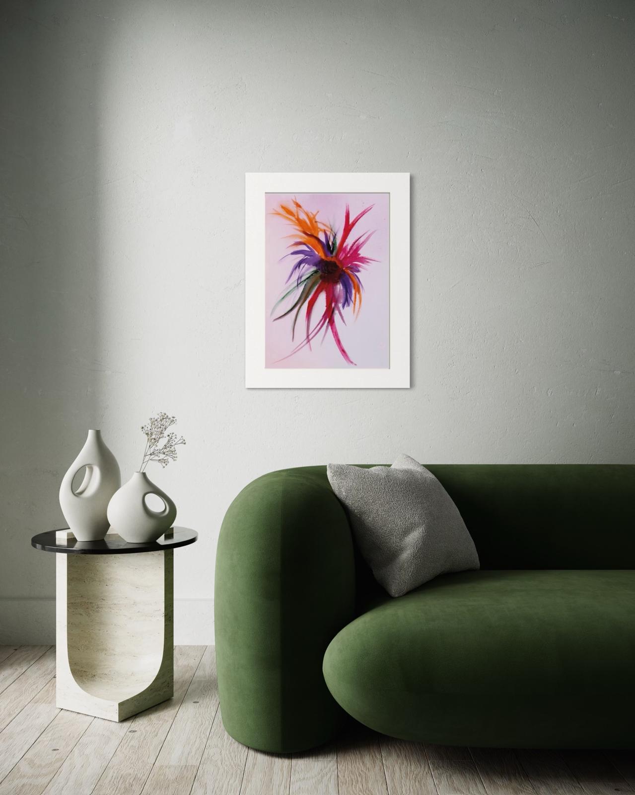 Modern living room with a green sofa, small table, and abstract art on the wall.